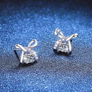 925 Sterling Silver Bow Earrings with Moissanite stone on dark blue sparkling background