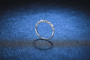 Detail of twisted sterling silver band set with sparkling pavé moissanite stones