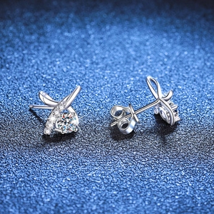 925 silver bow stud earrings featuring sparkling moissanite stones on dark blue texture