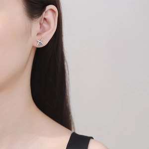 Elegant 925 sterling silver bow earrings with Moissanite stone worn by a female model