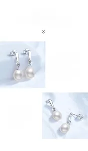 Close-up of S925 sterling silver drop earrings with freshwater pearl and moissanite