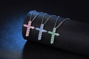 Detailed view of S925 silver cross necklaces with pink, blue, and green moissanite stones