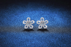 Macro shot of S925 silver sunflower stud earrings with shimmering moissanite stones
