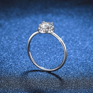 Classic round halo moissanite ring in 925 sterling silver on a navy blue background