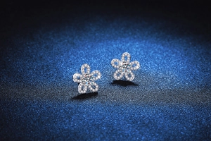 Close-up of S925 silver sunflower earrings with D-color moissanite stones