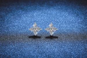 Macro shot of S925 sterling silver four-leaf clover stud earrings with sparkling moissanite
