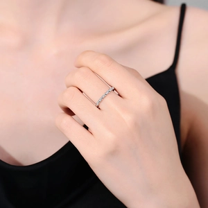 Elegantly twisted S925 silver moissanite eternity ring worn on a female hand