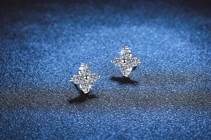 Macro shot of S925 sterling silver four-leaf clover stud earrings with sparkling moissanite