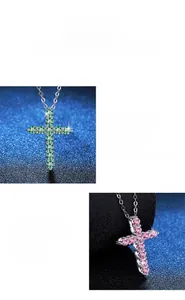 Macro detail of cross pendant featuring colorful moissanite stones and polished 925 silver
