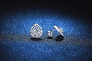Macro view of teardrop stud earrings with pavé moissanite stones in S925 silver