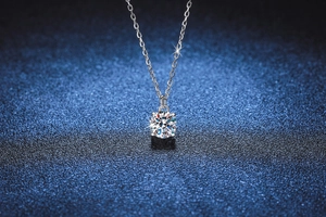 Detail of a 1 carat round moissanite pendant on a S925 sterling silver chain necklace