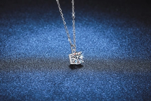 Macro shot of S925 silver necklace with four-prong set round brilliant moissanite pendant
