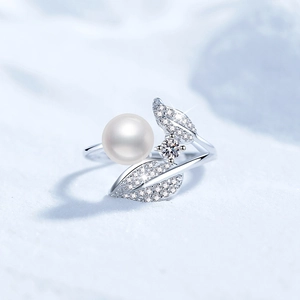 Detailed macro view of S925 silver leaf ring with freshwater pearl and moissanite accents