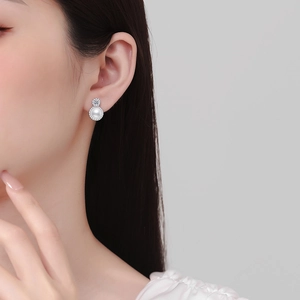 Elegant S925 silver stud earrings with moissanite top and halo-set white pearl on model