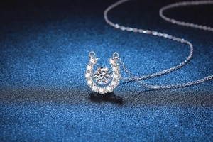 Macro shot of horseshoe-shaped S925 sterling silver necklace with floating Moissanite stone