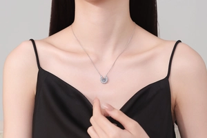 Close-up of s925 silver horseshoe necklace with sparkling 1ct moissanite on model