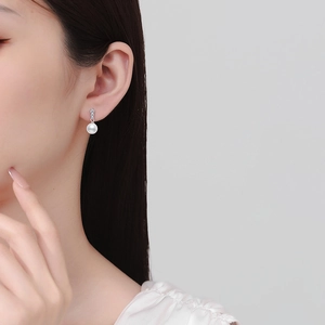 Elegant S925 silver stud earrings featuring natural freshwater pearls and moissanite stones