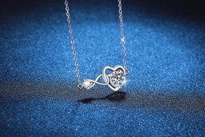 Macro shot of S925 silver heart necklace with infinity symbol and sparkling moissanite