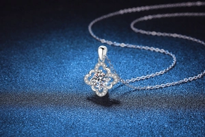 Macro shot of S925 sterling silver four-leaf clover pendant with sparkling moissanite