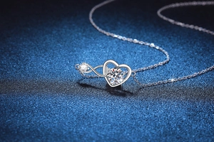 Close-up of S925 silver infinity heart pendant with a brilliant moissanite stone