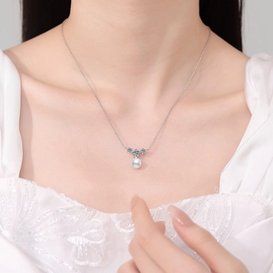 Elegant S925 silver necklace with white pearl and moissanite pendant on a female model