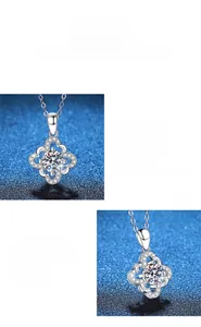 Macro detail of silver four-leaf clover pendant with 1 carat round moissanite
