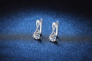 Detailed close-up of S925 sterling silver figure-8 earrings with 1 carat moissanite
