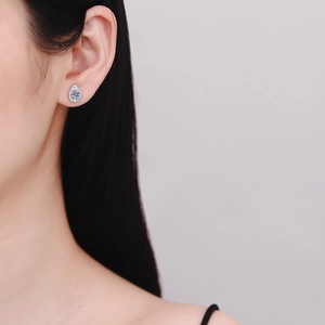 S925 sterling silver teardrop moissanite earrings with halo stones on a model