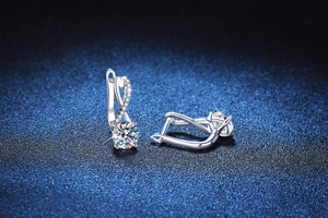 Macro detail of S925 silver moissanite earrings with a unique figure-eight twist design