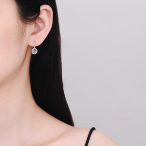 Elegant S925 sterling silver drop earring with round moissanite on a female model