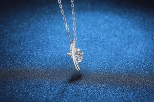 Macro shot of 1 carat moissanite pendant with curved diamond-set edges on silver chain