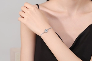 Close-up of s925 silver sunflower bracelet with moissanite stones on a woman wrist