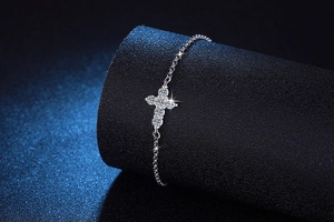 Close-up of S925 sterling silver bracelet featuring a sparkling moissanite cross pendant