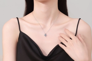Elegant s925 silver necklace featuring a 1 carat round moissanite pendant on a female model