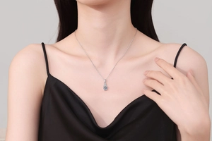 Close-up of S925 sterling silver necklace with cushion-cut moissanite pendant on model