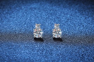 Macro detail of S925 sterling silver four-prong earrings with round cut moissanite stones