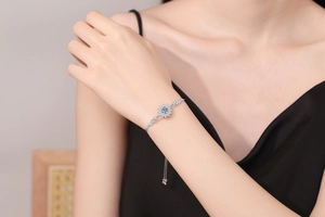 Detail of adjustable 925 sterling silver sunflower bracelet with sparkling moissanite on wrist