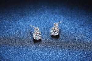 Detailed macro view of S925 sterling silver four-prong moissanite stud earrings