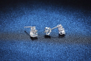 Macro view of double-stone S925 silver stud earrings with round moissanite in four-prong setting