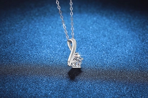 Macro shot of 1 carat moissanite infinity pendant on a 925 silver necklace chain