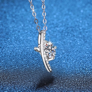 S925 sterling silver necklace with 1 carat round Moissanite pendant on blue background
