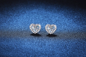 Macro view of S925 sterling silver heart-shaped stud earrings with sparkling moissanite stones