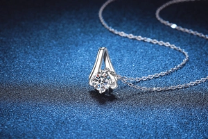 Detailed macro view of 1 carat moissanite stone in a V-shaped sterling silver setting