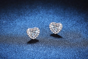 Close-up of S925 sterling silver heart-shaped halo stud earrings with brilliant moissanite