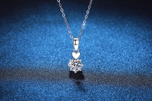 Detail of S925 silver necklace featuring a 1ct round moissanite in a 6-prong heart setting