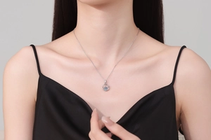 Close-up of S925 sterling silver Moebius necklace with 1 carat Moissanite on a model