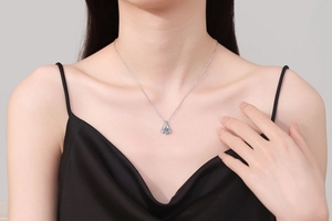 Detail of 1 carat moissanite pendant on S925 sterling silver chain worn by model