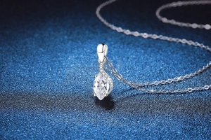 Detailed close-up of S925 silver marquise cut moissanite pendant on a blue background