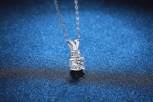 Macro shot of S925 sterling silver moissanite necklace with four-prong rabbit ear pendant