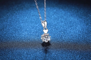 Macro view of S925 silver necklace with heart-shaped bail and six-prong moissanite pendant